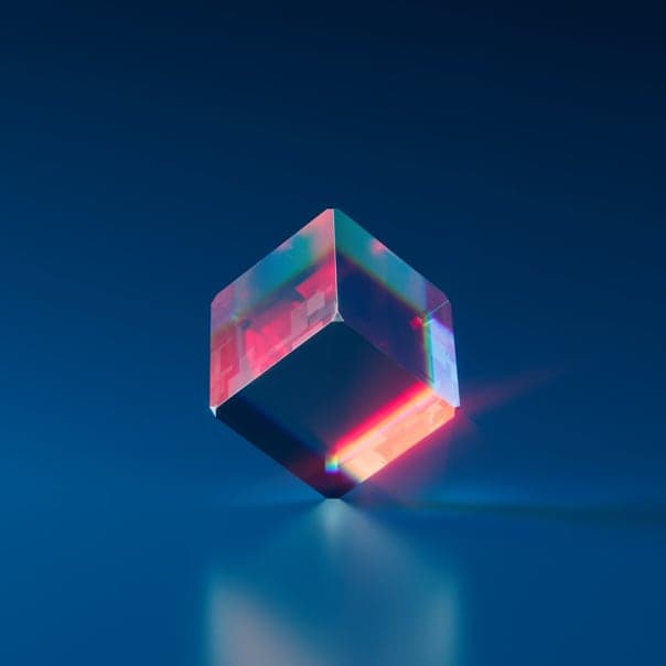 An acrylic dice standing on one vertix